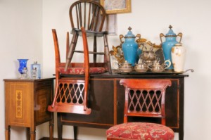 antiques chairs stacked on top of a side board