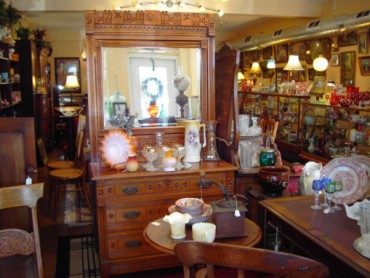 antique dresser surrounded by other antiques