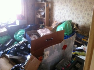 cardboard box and mixed rubbish inside a property
